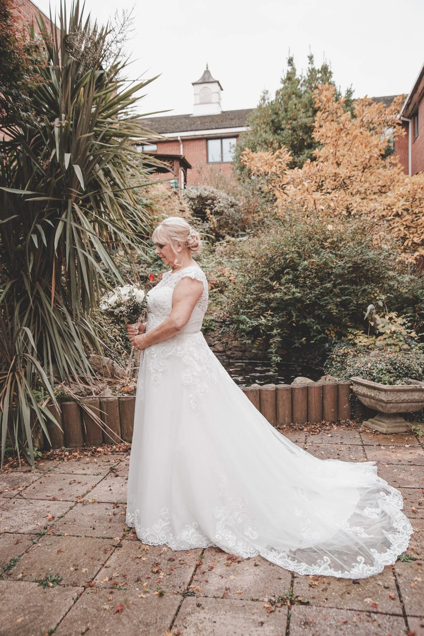 Bride posing with flowers bouquet on her wedding day at Arden Hotel in Coventry