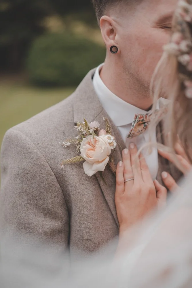 Details of the wedding ring and chest flower