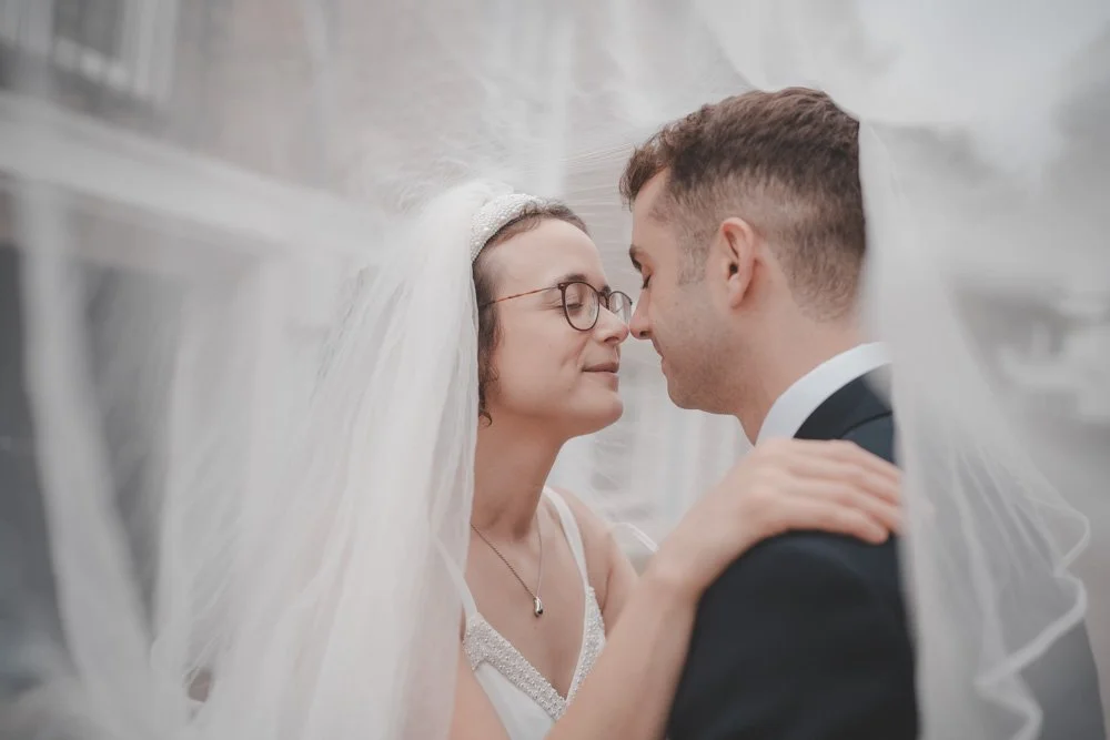Close-up intimate portrait of bride and groom, on the streets of London during the couple photoshoot on their wedding day