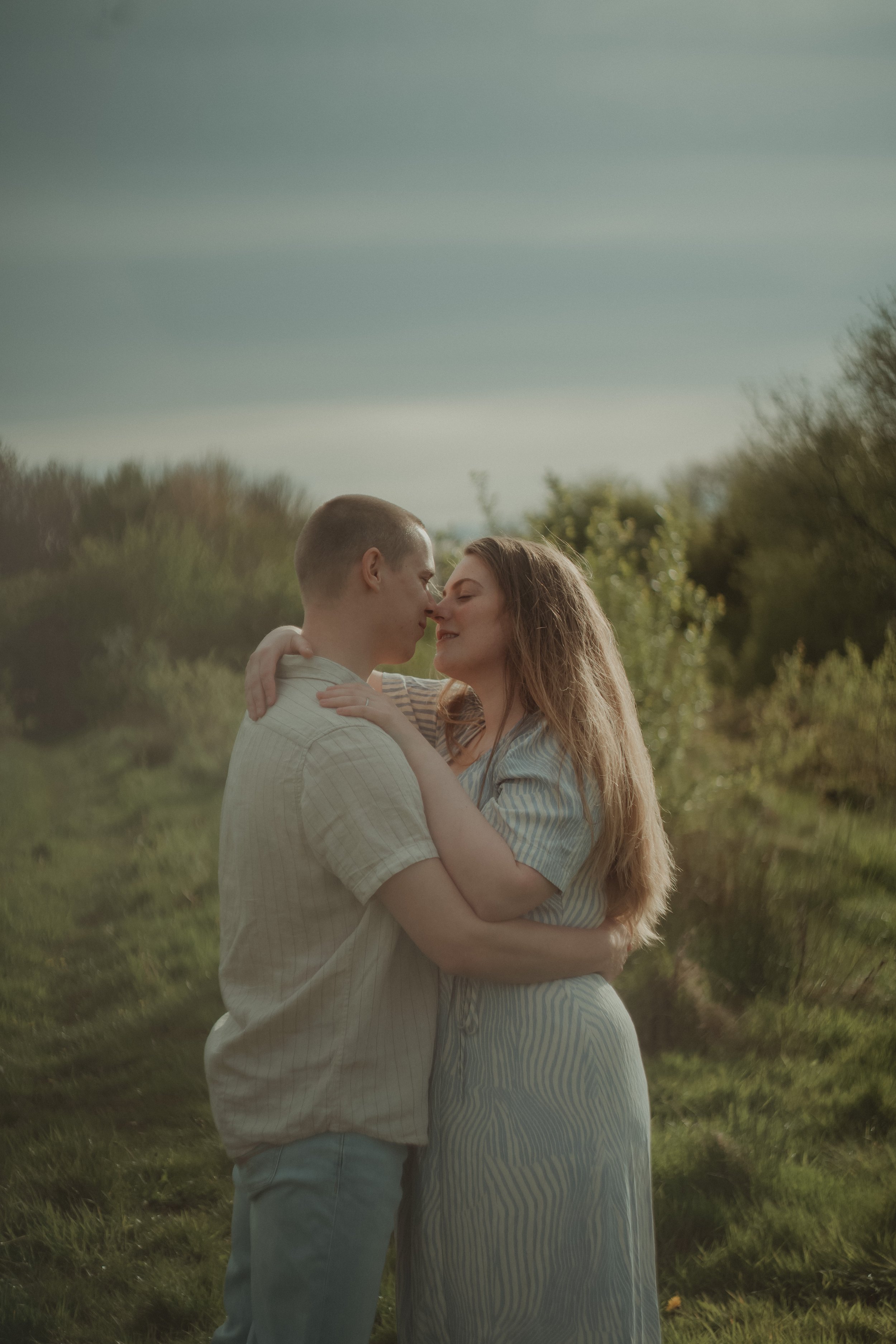 Portrait of a couple holding each other close, at their pre-wedding photo session in Hoveringham
