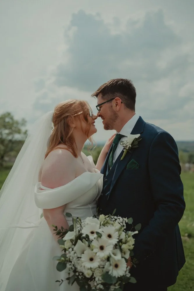 Vertical portrait of young bride and groom at The White Hart Inn at Lydgate