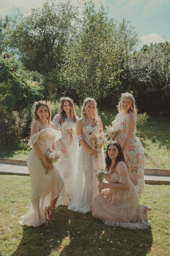 Bride and bridesmaids photographed on a sunny wedding day at Gwesty'r Emlyn Hotel in Newcastle, Wales