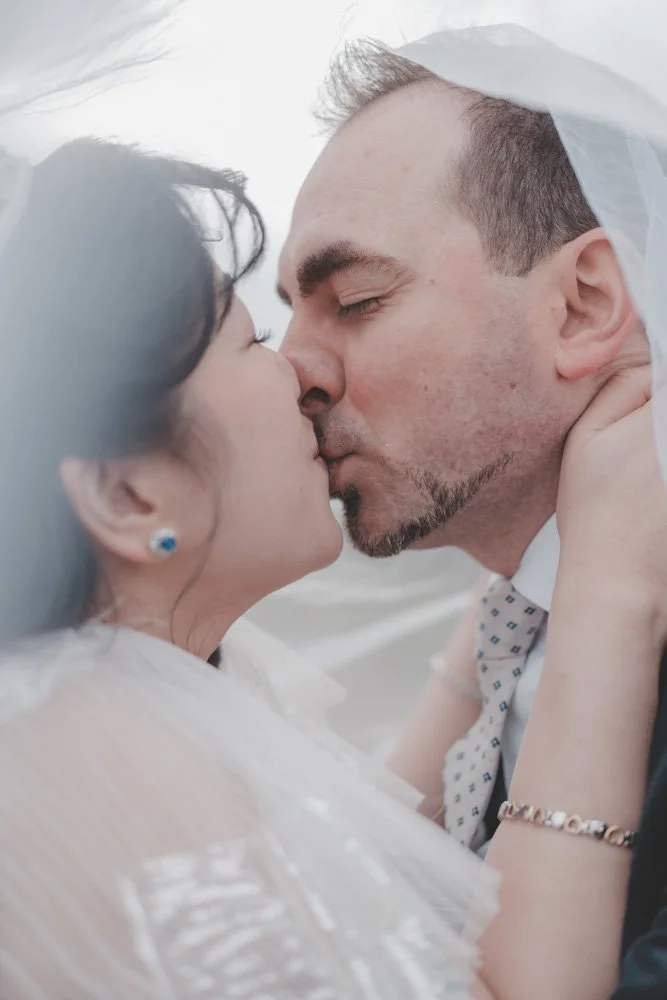 Close-up portrait of bride and groom kissing each other 