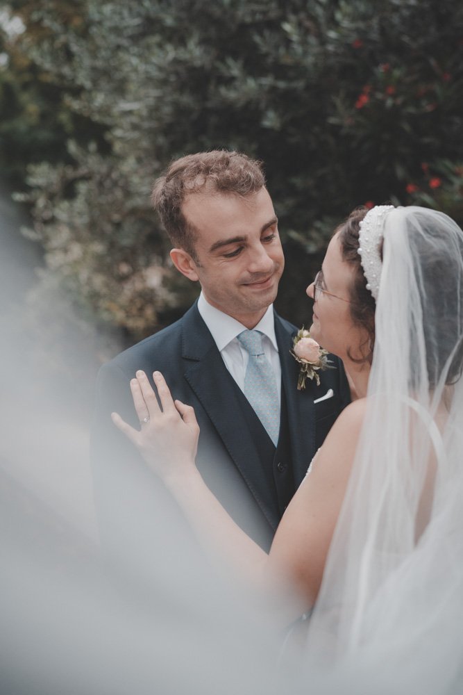 Close-up portrait of newly wedded couple, on their wedding day on the streets of London
