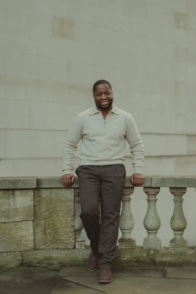 Man posing for the camera in front of a building, in London, UK