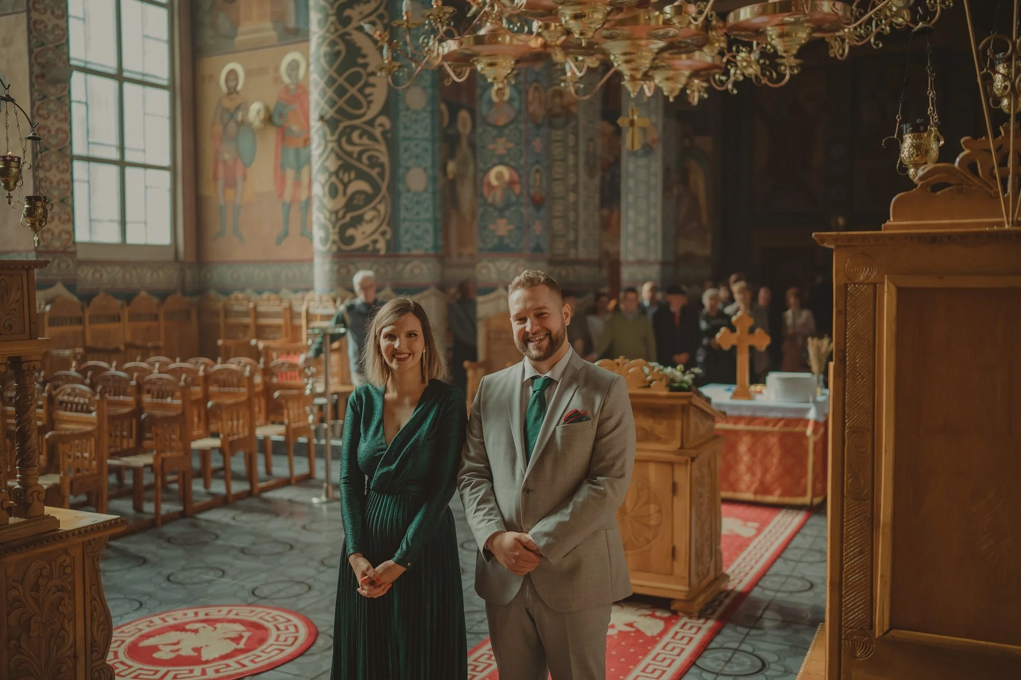 Portrait of a mother and father on the during their daughter Christening ceremony at Biserica Naşterea Domnului, Cluj-Napoca, Romania