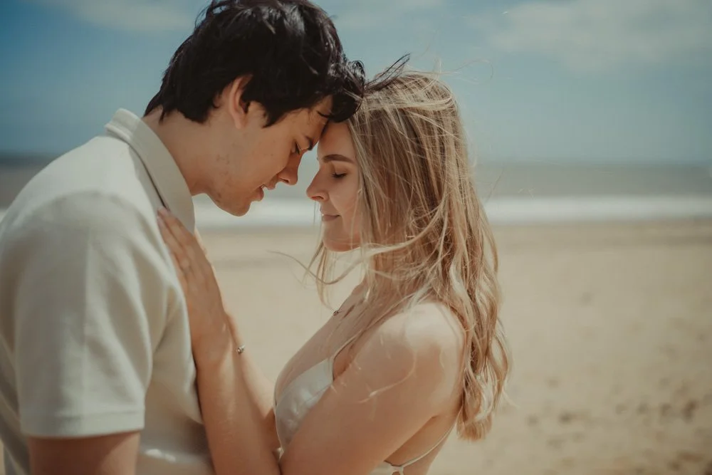 Close-up portrait of a young couple close to each other, at Covehithe Beach