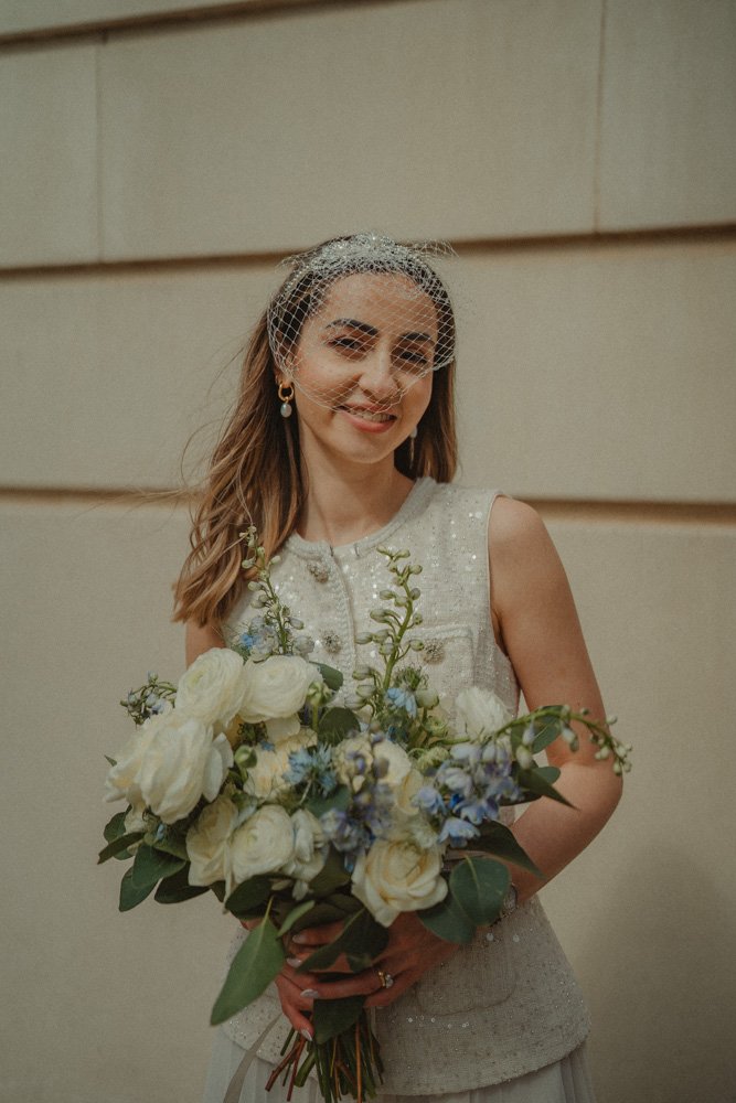 Portrait of a young bride holding her flower bouquet in Brindleyplace Square in Birmingham