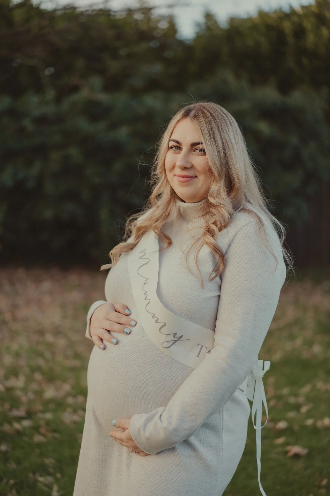 Portrait of a pregnant woman at her baby shower party, at the 
Millpool, Coventry, West Midlands