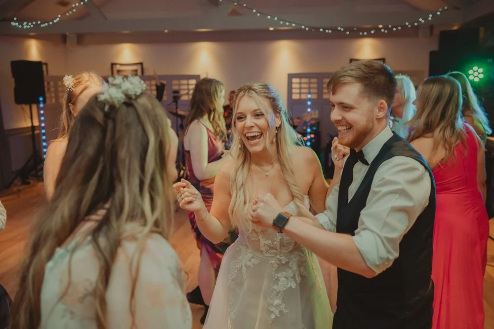 Bride and groom having fun on the dancefloor at Gwesty'r Emlyn Hotel in Newcastle, Wales