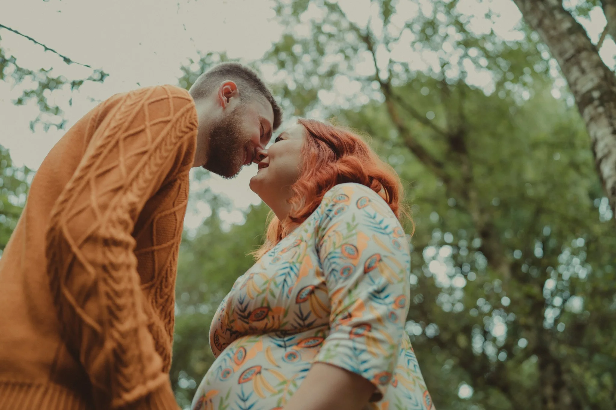 Portrait of pregnant couple kissing during their save the date photosession