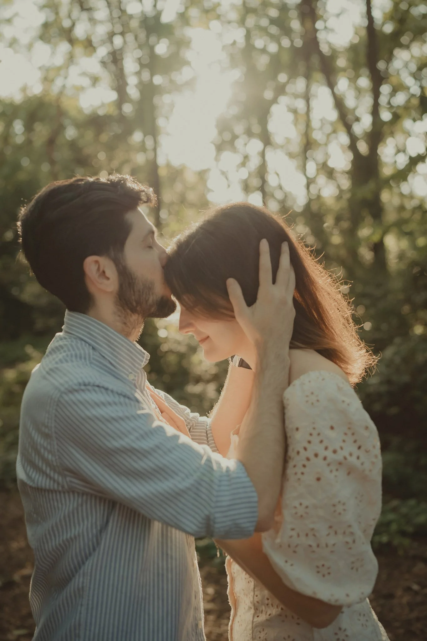Boy kissing her girlfriend's forehead 
