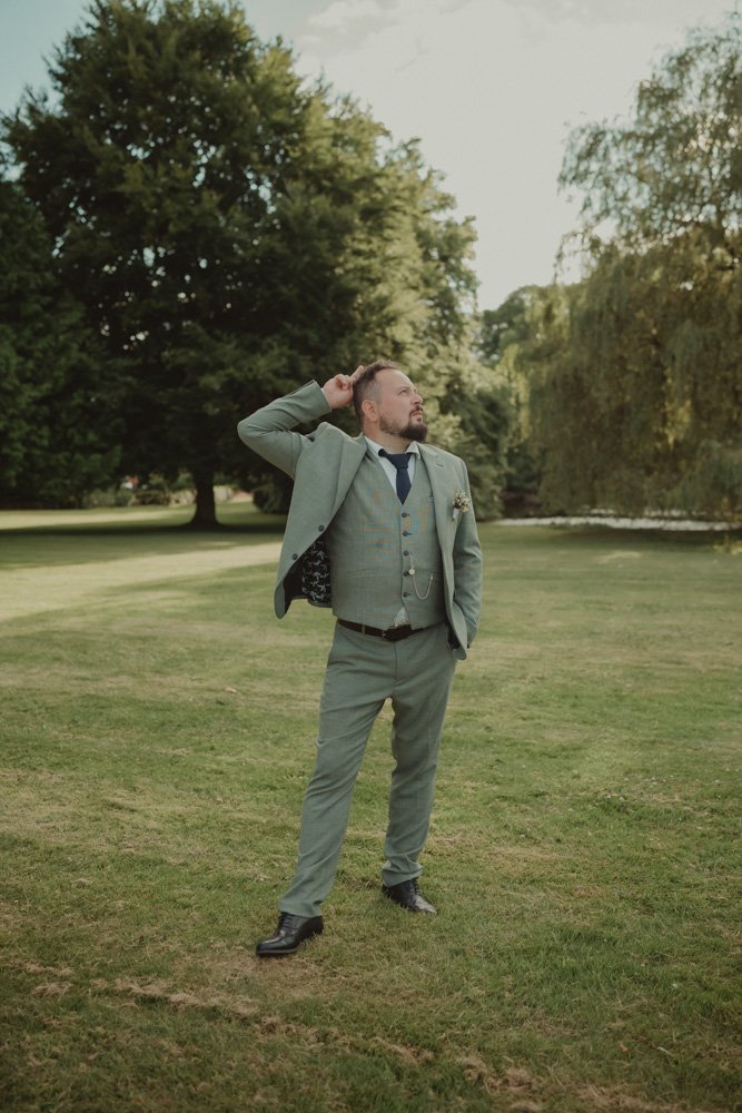 Groom posing funny for a photo at Brockencote Hall Hotel, Kidderminster