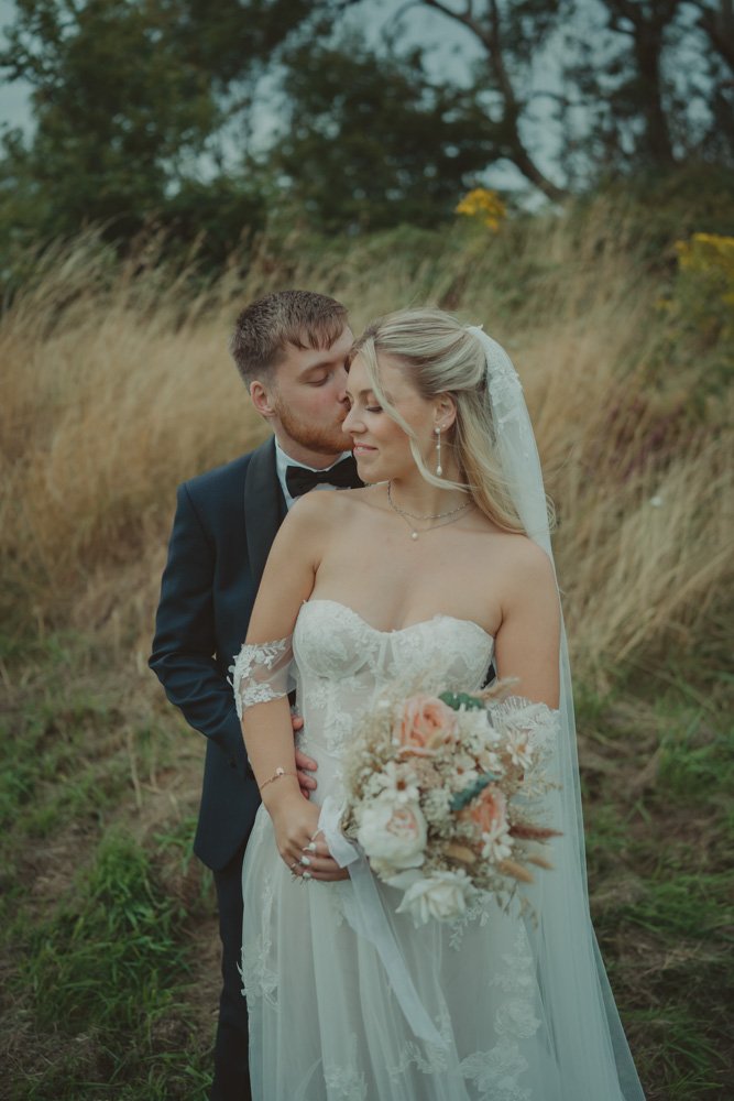 Verical photo of bride and groom together at Gwesty'r Emlyn Hotel in Newcastle, Wales