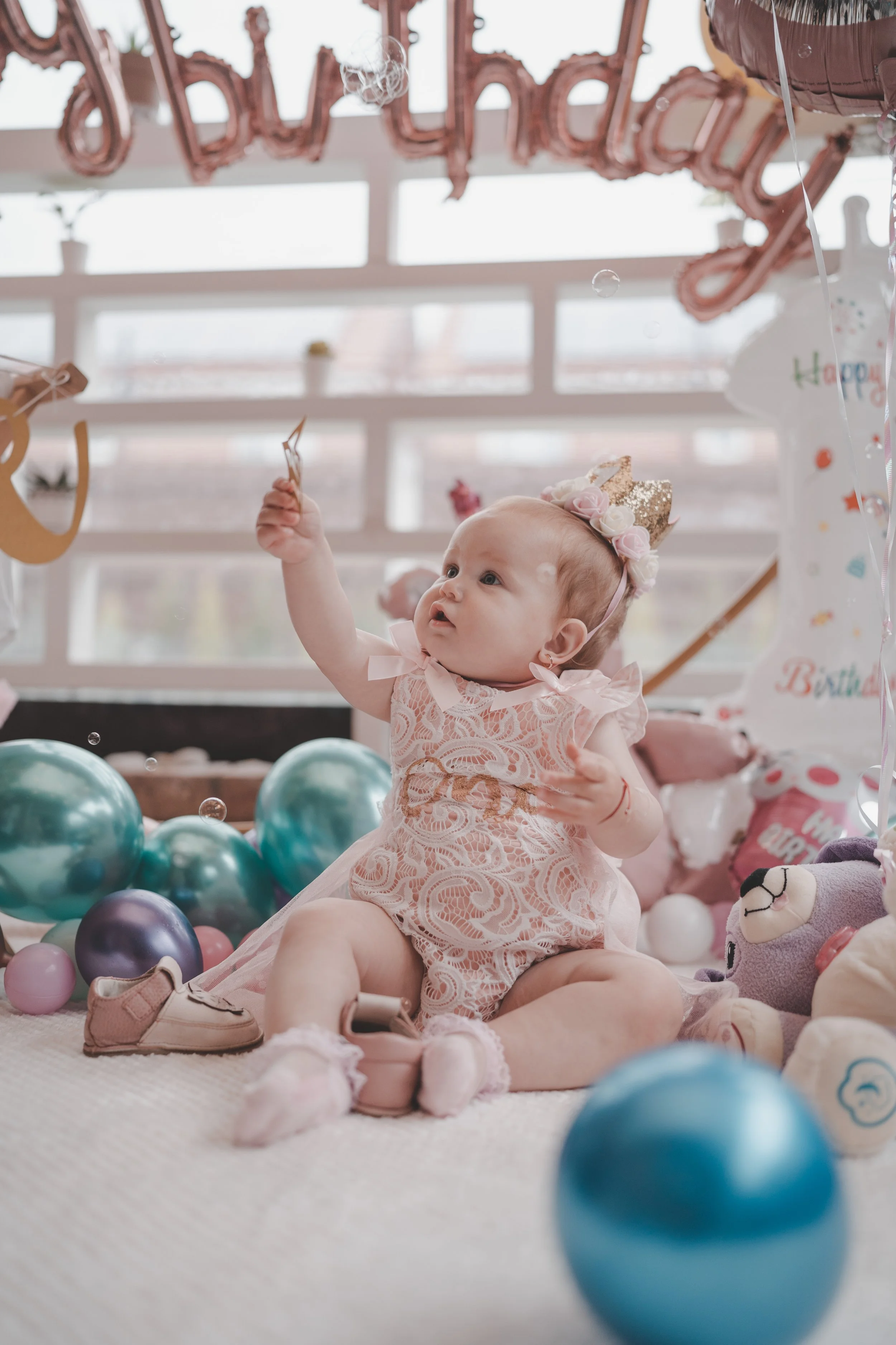 Little girl wearing a crown at her smash the cake birthday party