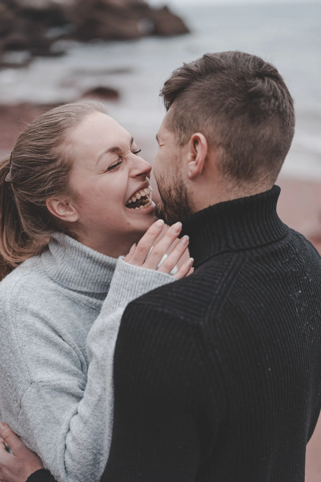 Couple having a great time together during their photoshoot in Cornwall