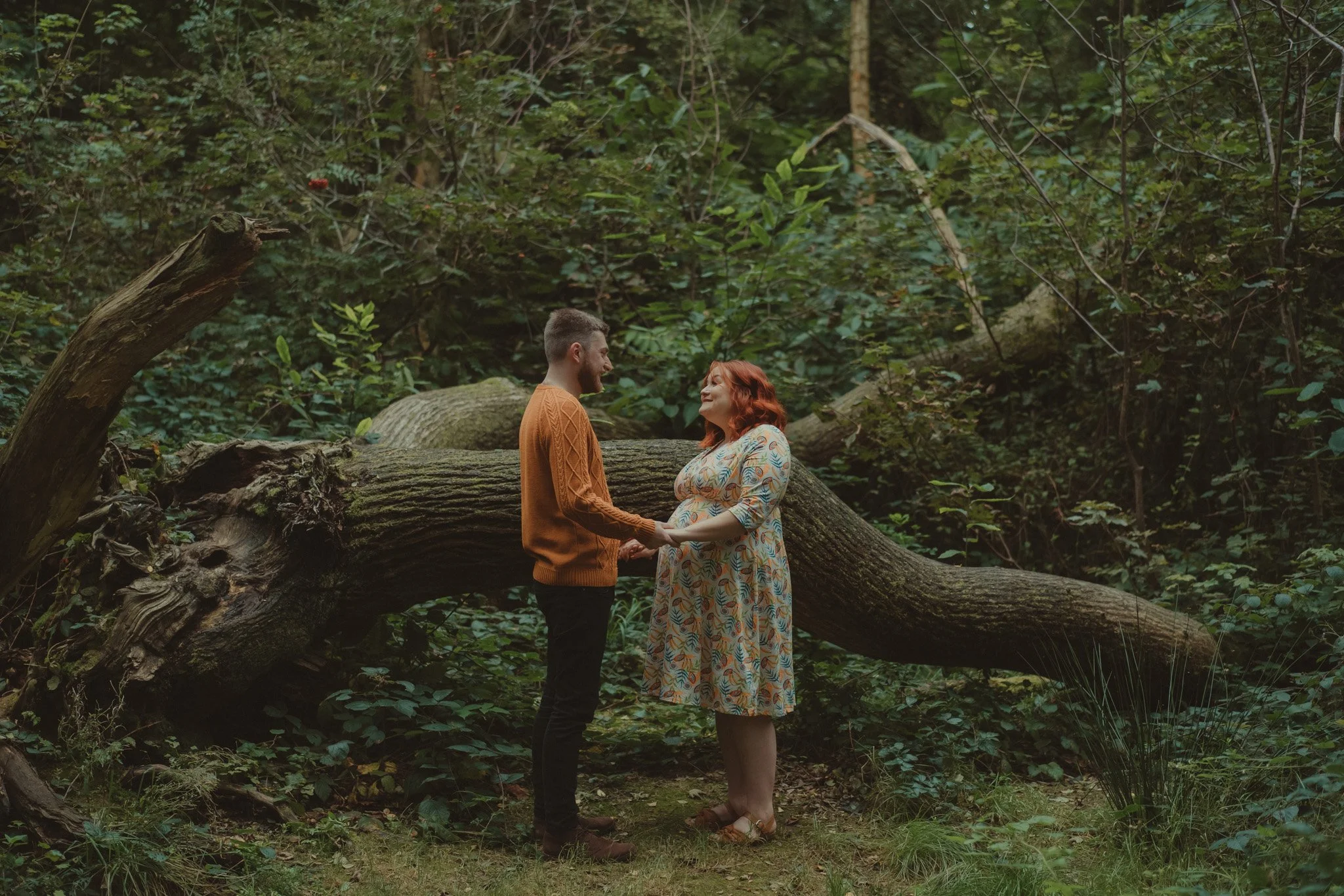 Pregnant woman and her future husband holding hands during a Sate the Date photoshoot in Derbyshire