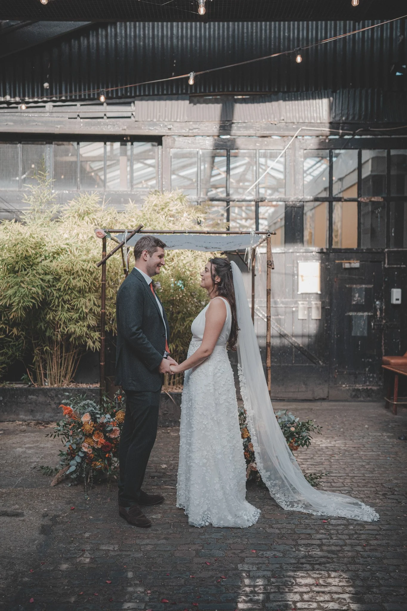 Bride and groom in front of the altar during their wedding ceremony at the Depot in London