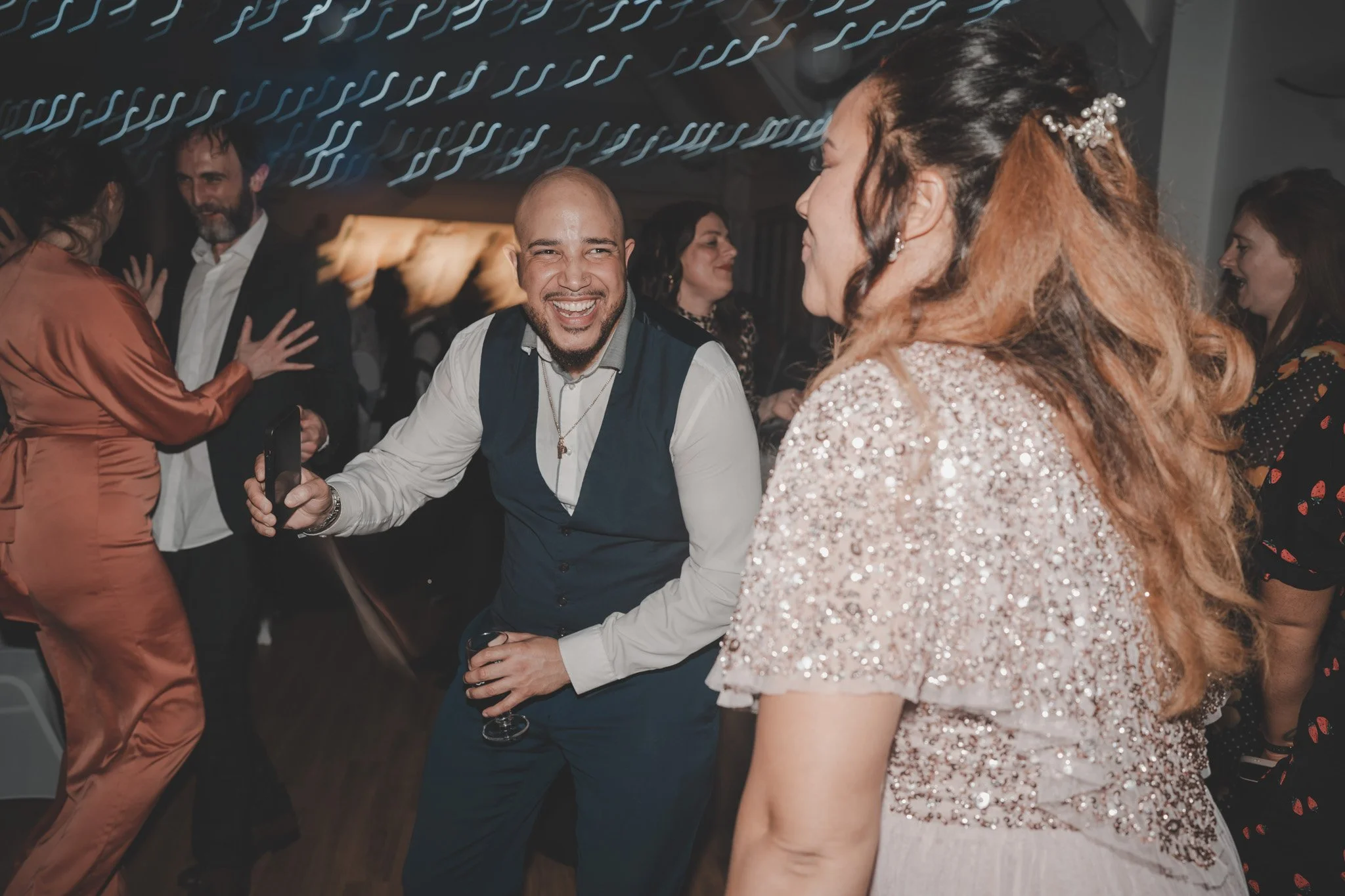 Wedding guests having fun on the dance floor at The Eastrea Centre, Cambridgeshire