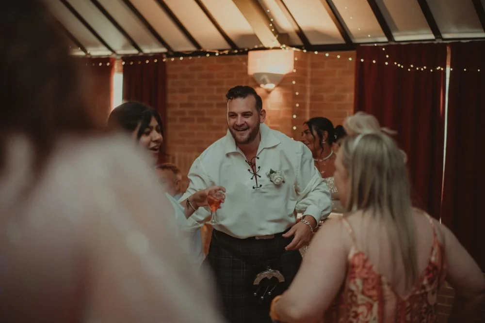 Wedding guests photographed dancing on the dancefloor at a UK wedding