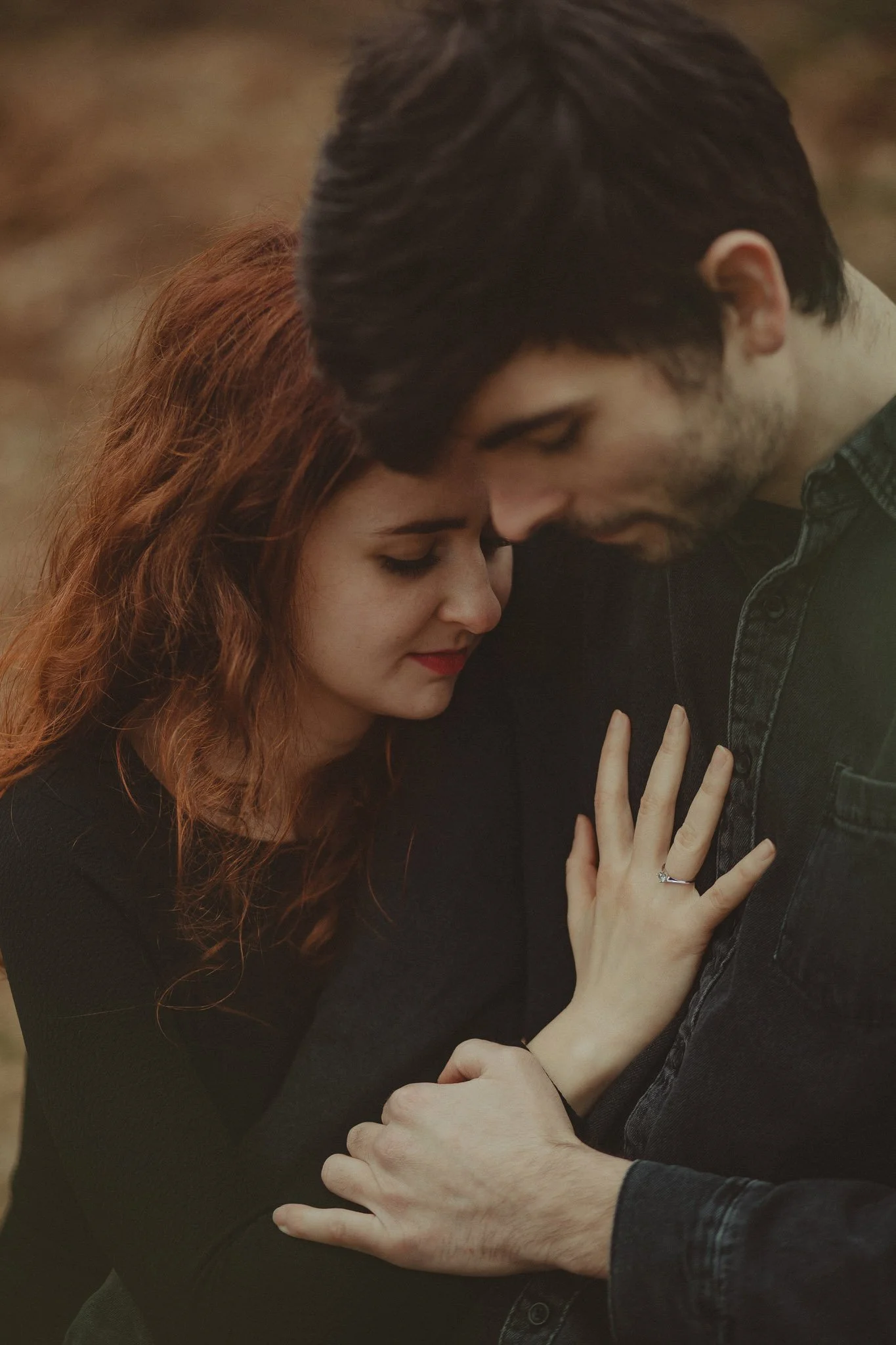 Young couple showing the engagement ring on a save the date photo session