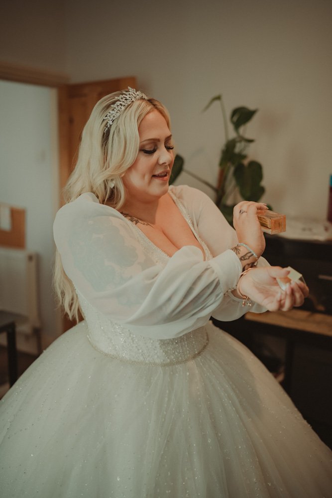Portrait of bride putting perfume on in Portsmouth 