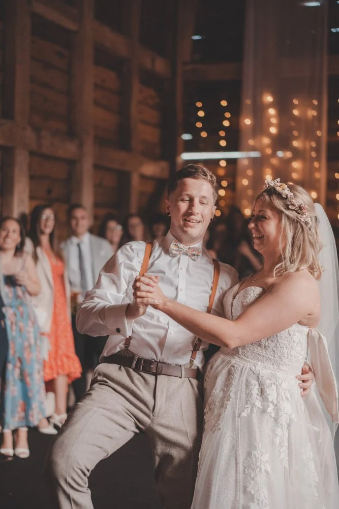 Funny photo of bride and groom laughing and dancing on the dance floor at The Courtyard at Shelsley Walsh