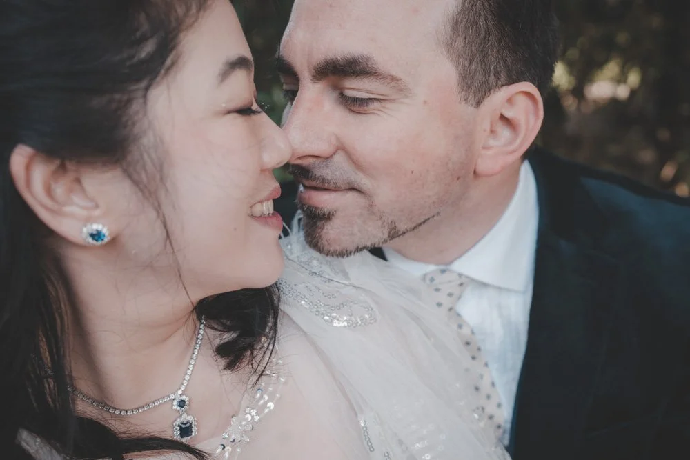Close up portrait of a bride and groom smiling