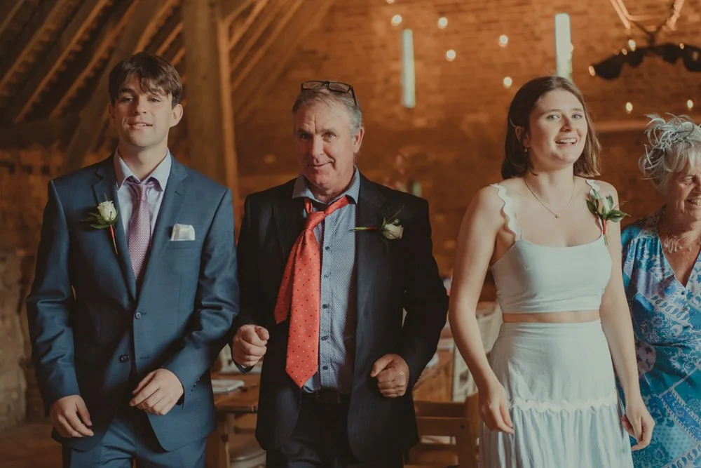 Wedding guests, two men and two women, dancing on the dance floor in a wedding barn in Drayton, Oxfordshire