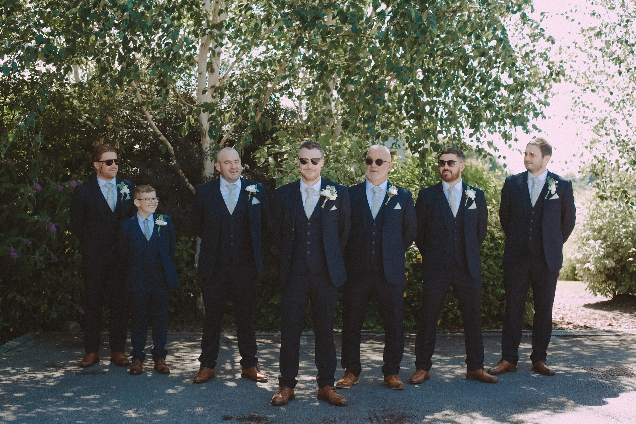 Outdoor group photo of groom with the grooms men