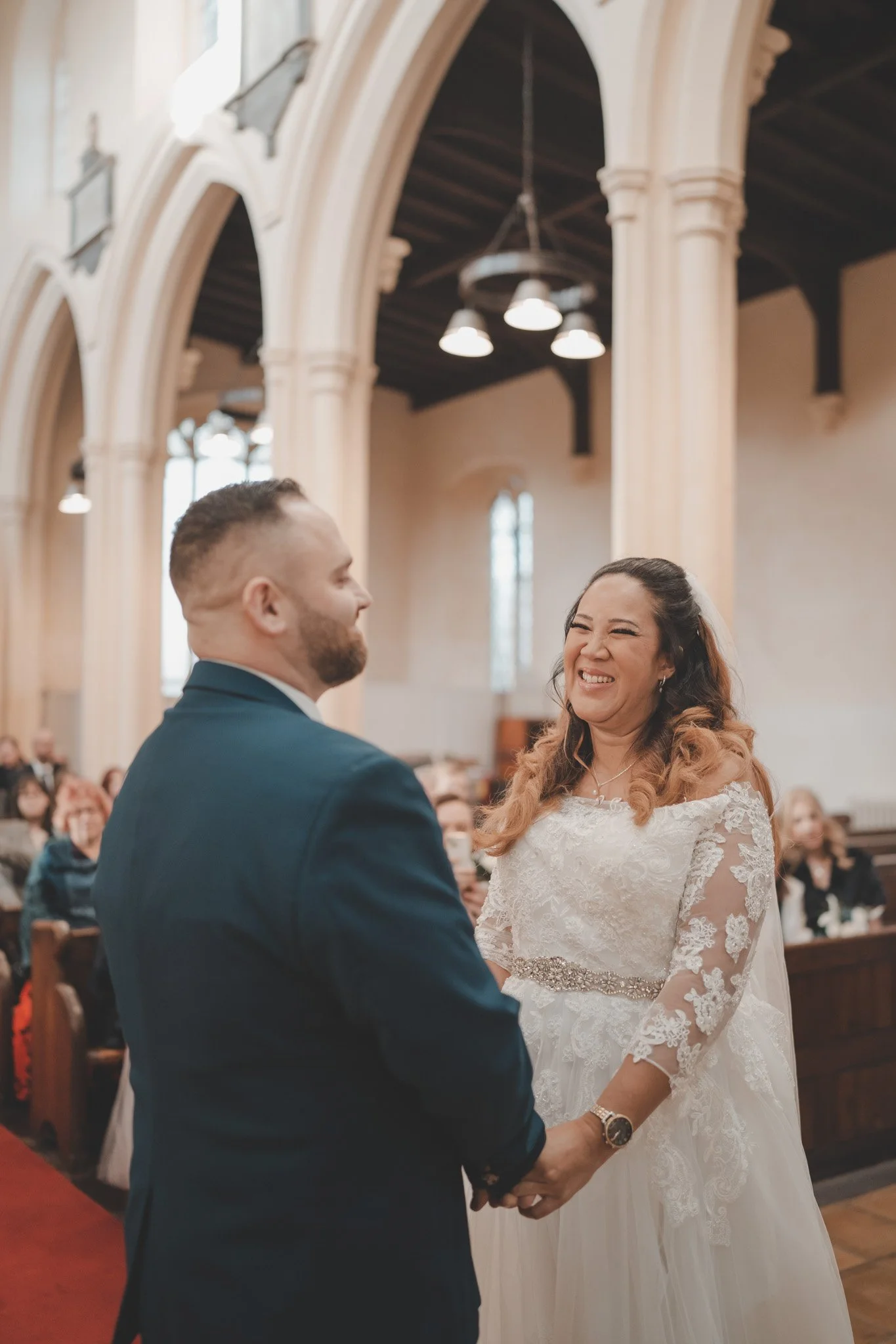 Bride and groom getting emotional during their religious ceremony at St Andrews Church, Whittlesey, Cambridgeshire