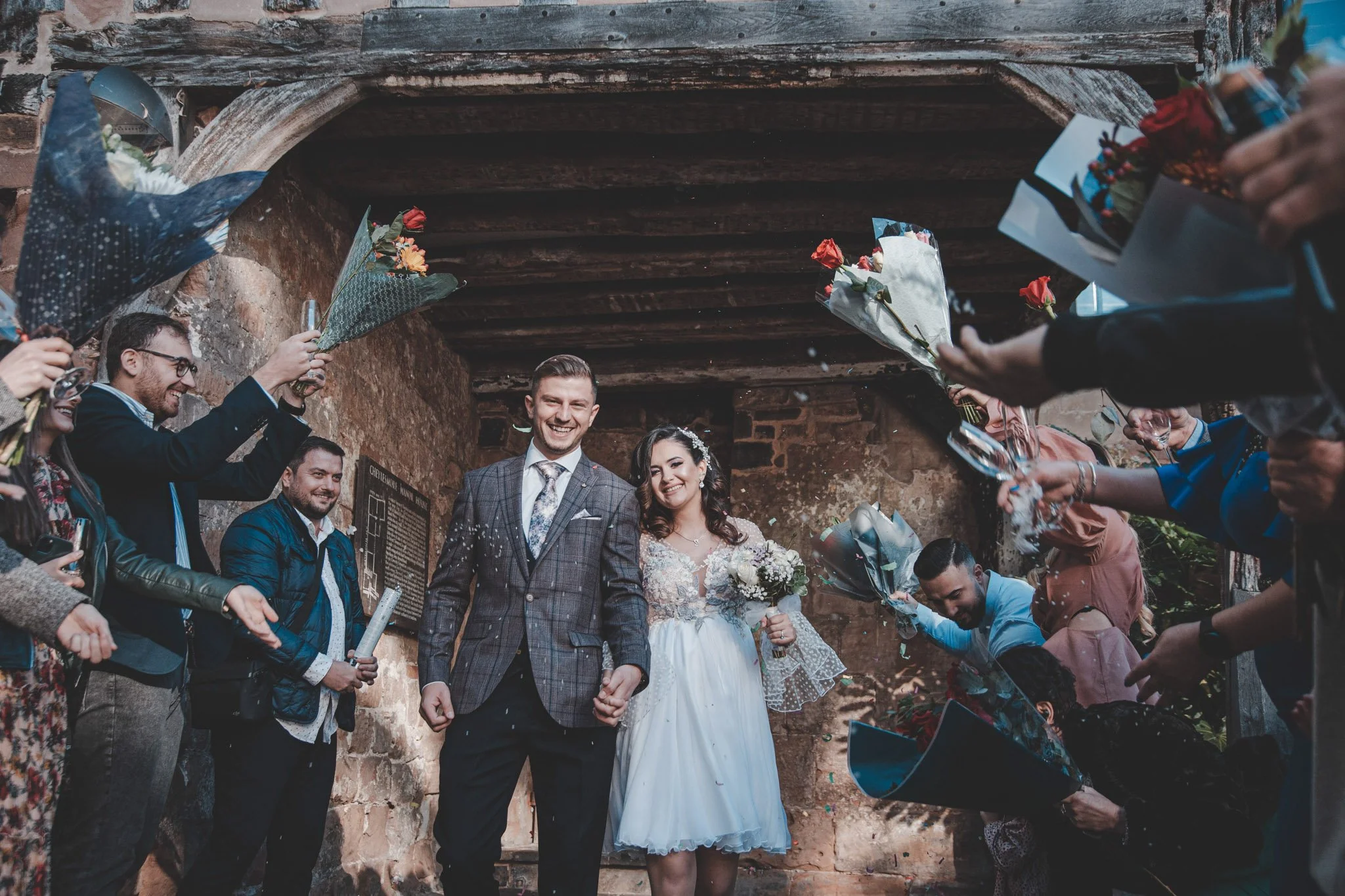 Bride and groom welcomed by guests after their wedding ceremony