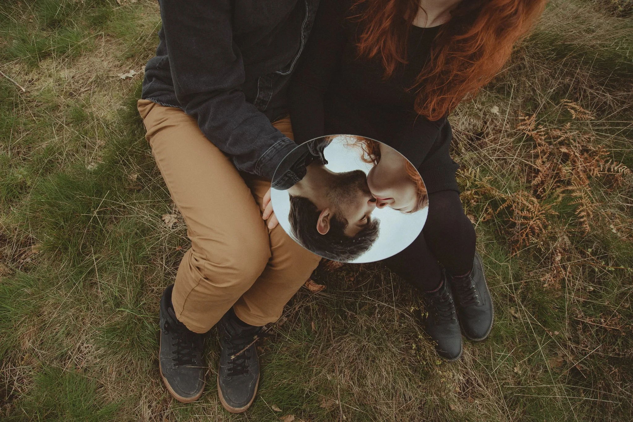 Young couple sharing a kiss at their save the date photoshoot in Lickey Hills, Birmingham