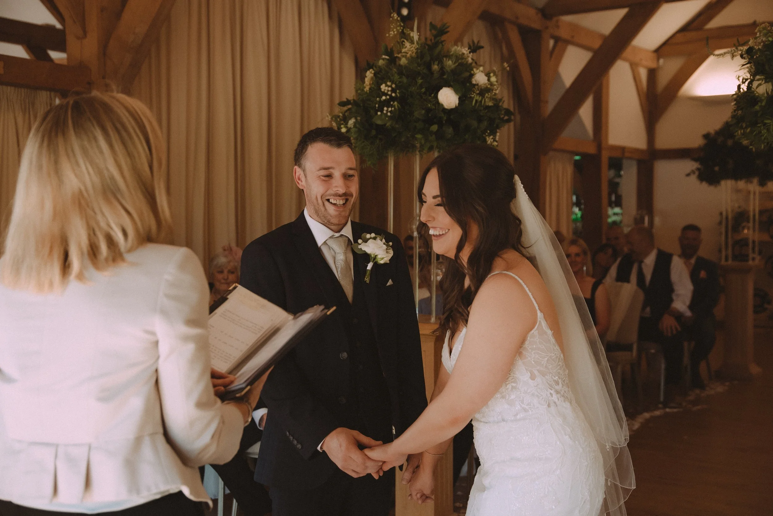 Bride and groom laughing during their wedding ceremony at Sandhole Oak Barn Wedding Venue