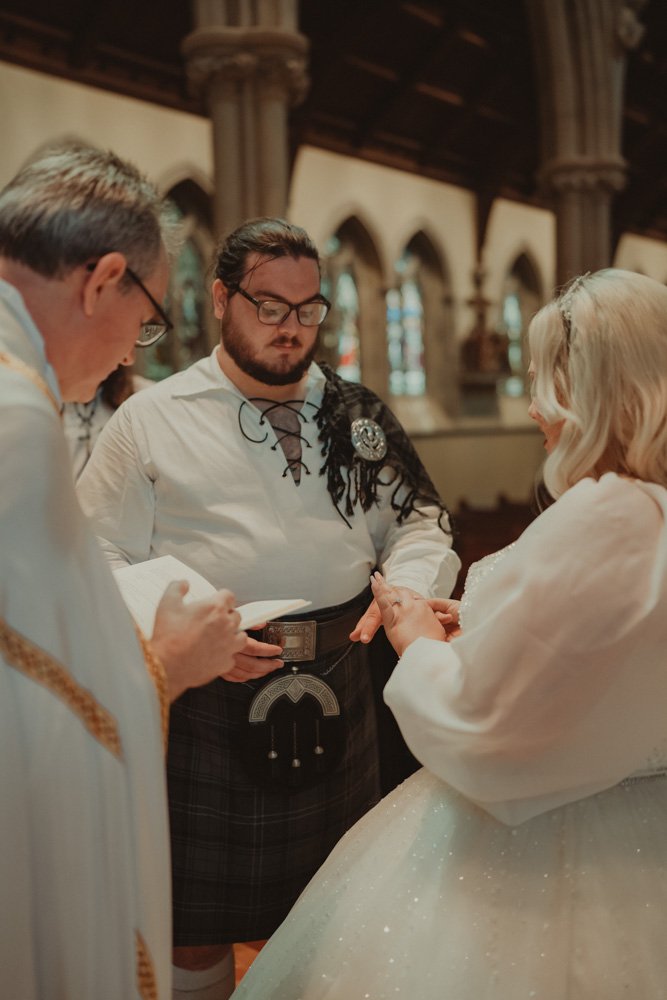 Exchanging of rings during a religious wedding ceremony at St. John's Portsmouth Catholic Cathedral
