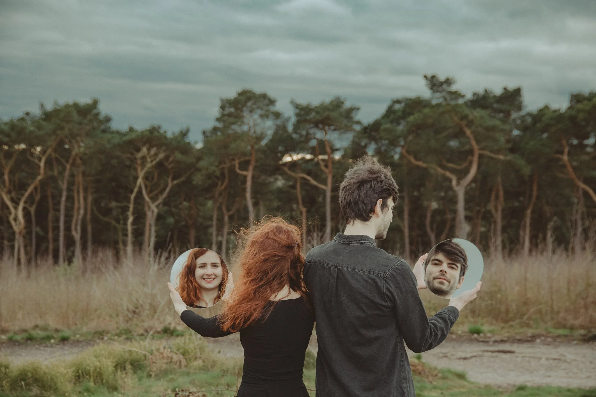 Young couple using mirrors as props during an engagement shoot in Birmingham