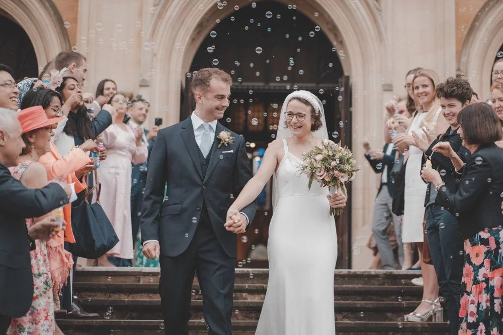 Bubble exit after religious wedding ceremony at St Benedict's Ealing Abbey, London