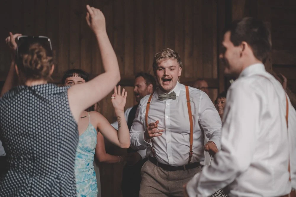 Wedding guests photographed aving fun on the dance floor at The Courtyard at Shelsley Walsh