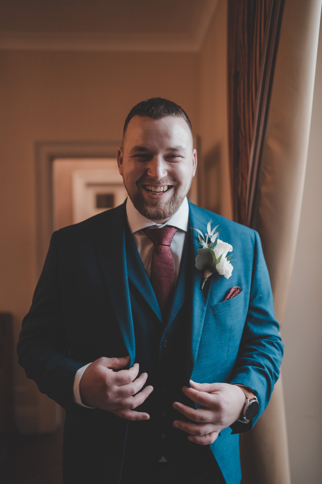 Portrait of a groom smiling at Cockliffe Country House, Nottingham, in the morning of his wedding day