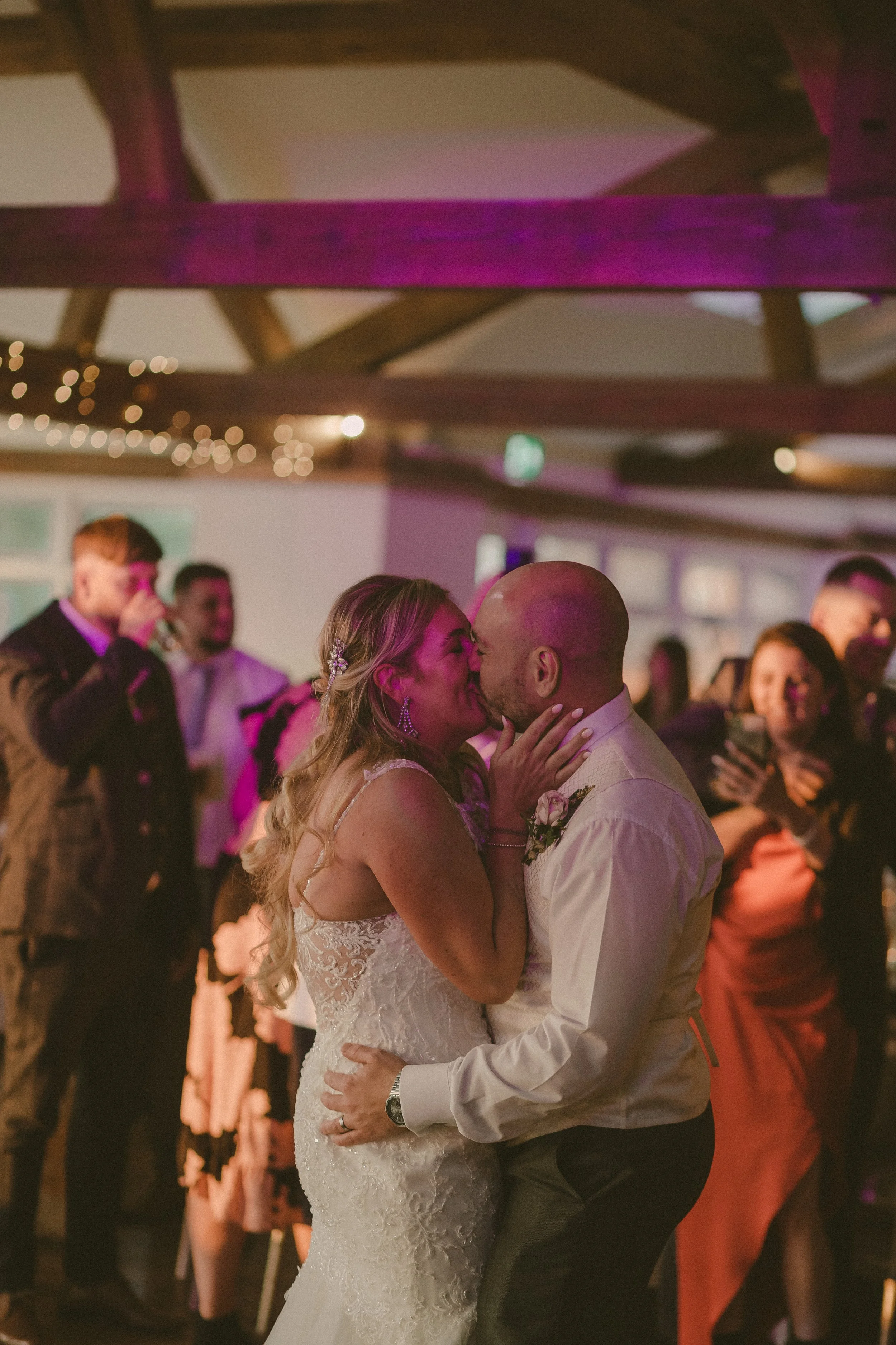 Bride and groom kissing while having their first dance in a West Midlands venue
