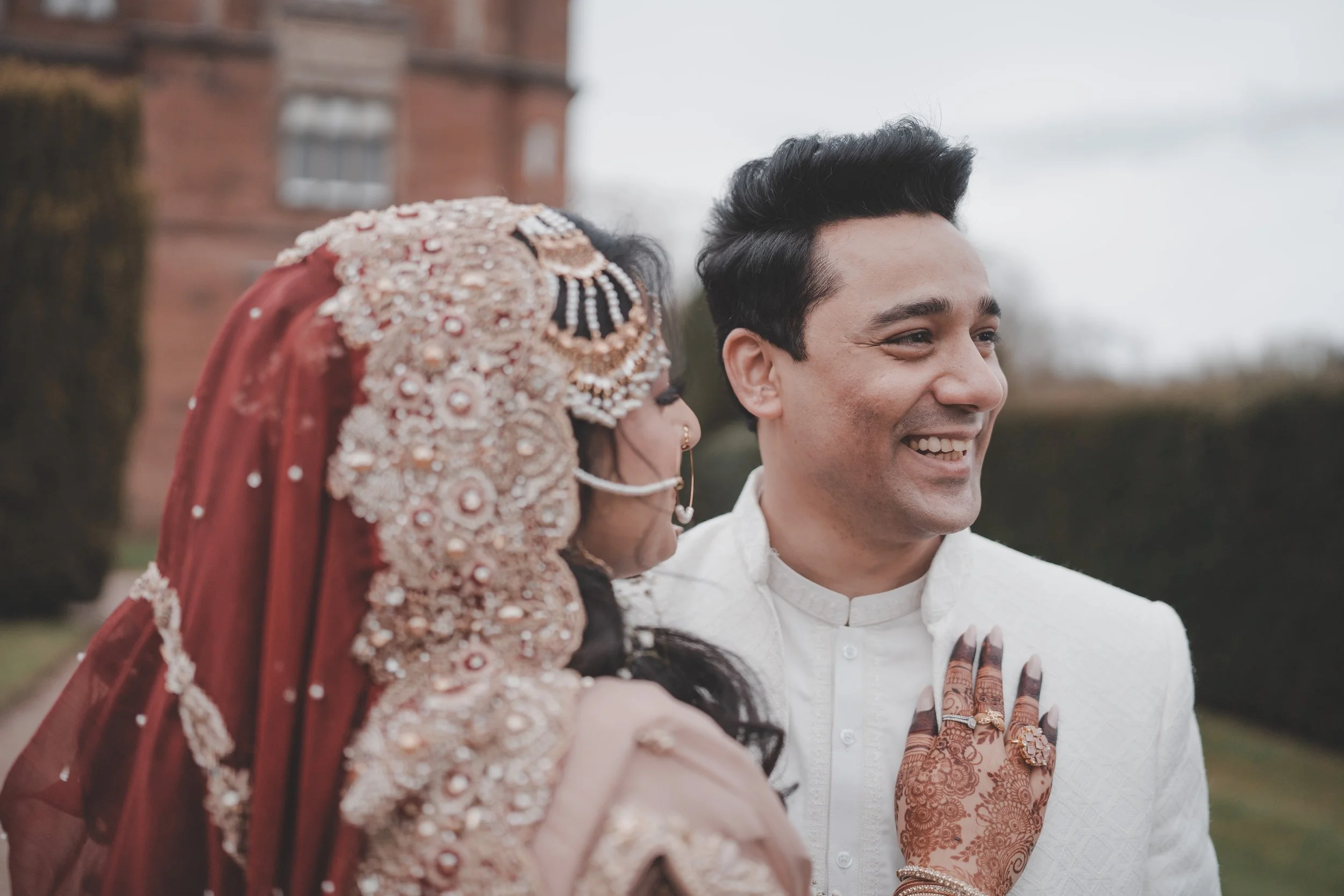 Portrait of bride and groom holding each other and laughing 