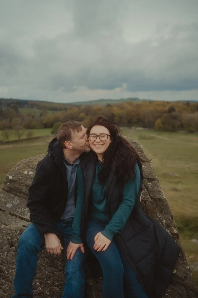Man kissing his girlfriend during a pre-wedding photoshoot
