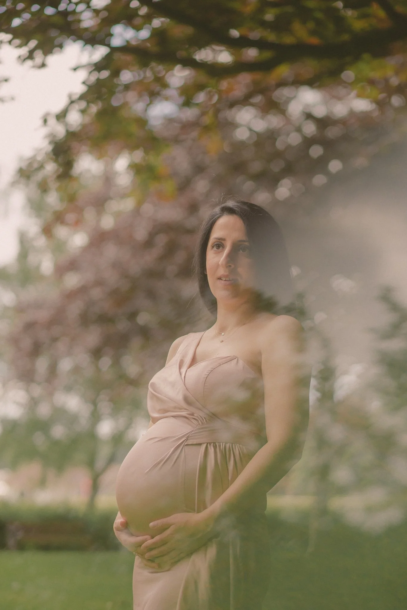 Portret of a pregnant woman posing, in War Memorial park, Coventry 