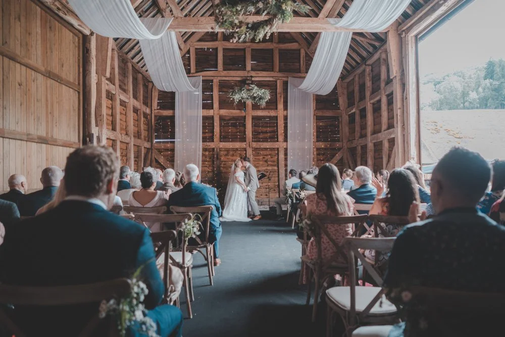 Wedding ceremony in a barn, at The Courtyard at Shelsley Walsh.