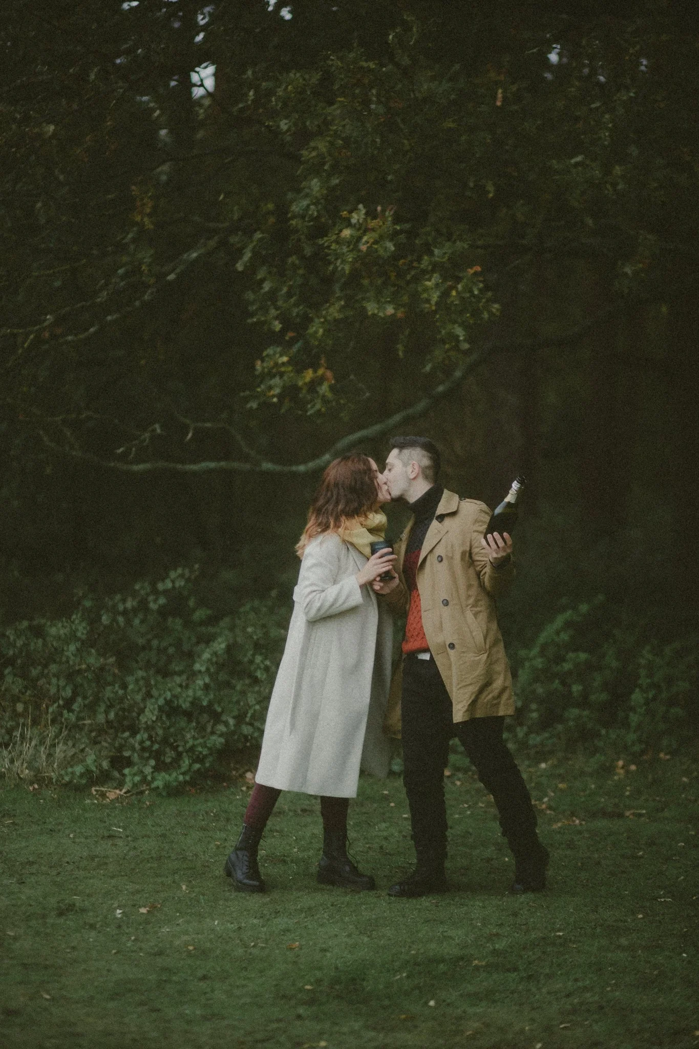 Couple sharing a kiss at their save the date photoshoot in Coombe Abbey, Coventry