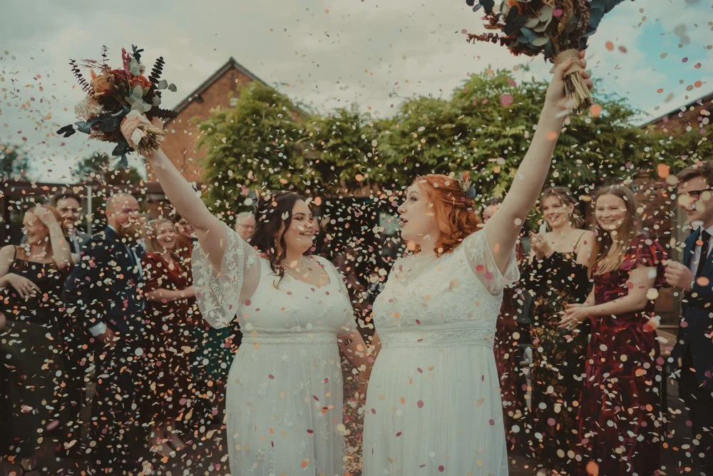 LGBTQ wedding, two brides after a confetti exit, at The Chester Fields Country Pub, Restaurant & Wedding Venue, UK