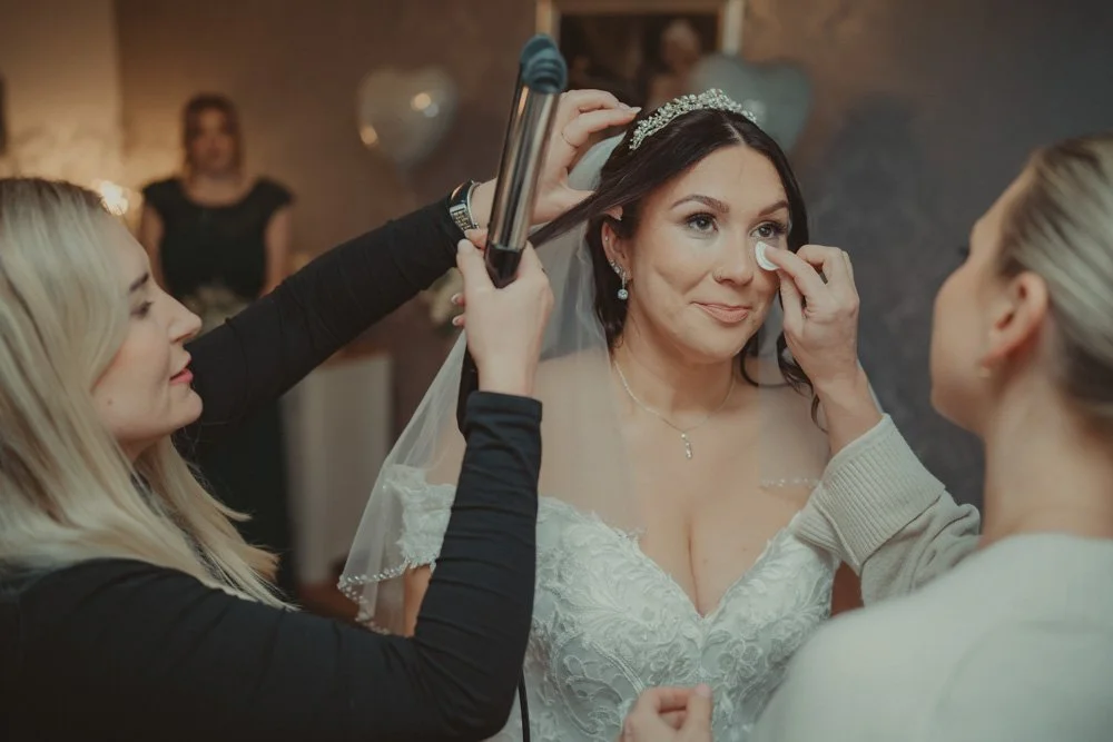 Bride getting make-up on on the wedding day, at her mom's house in Swadlincote, UK