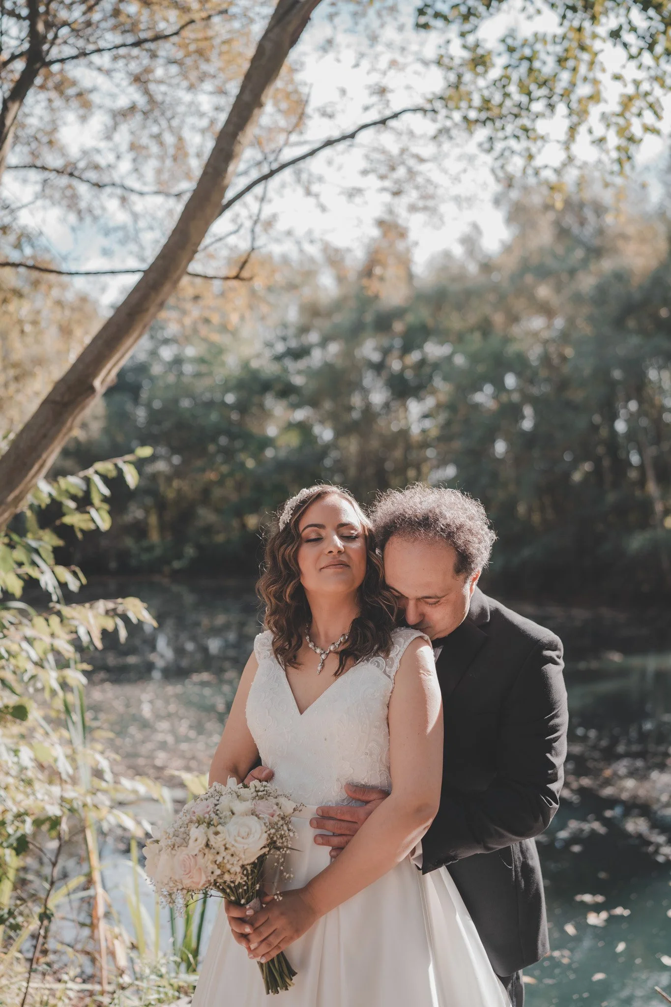 Bride and groom during their photoshoot at Delapre Lake, Northampton