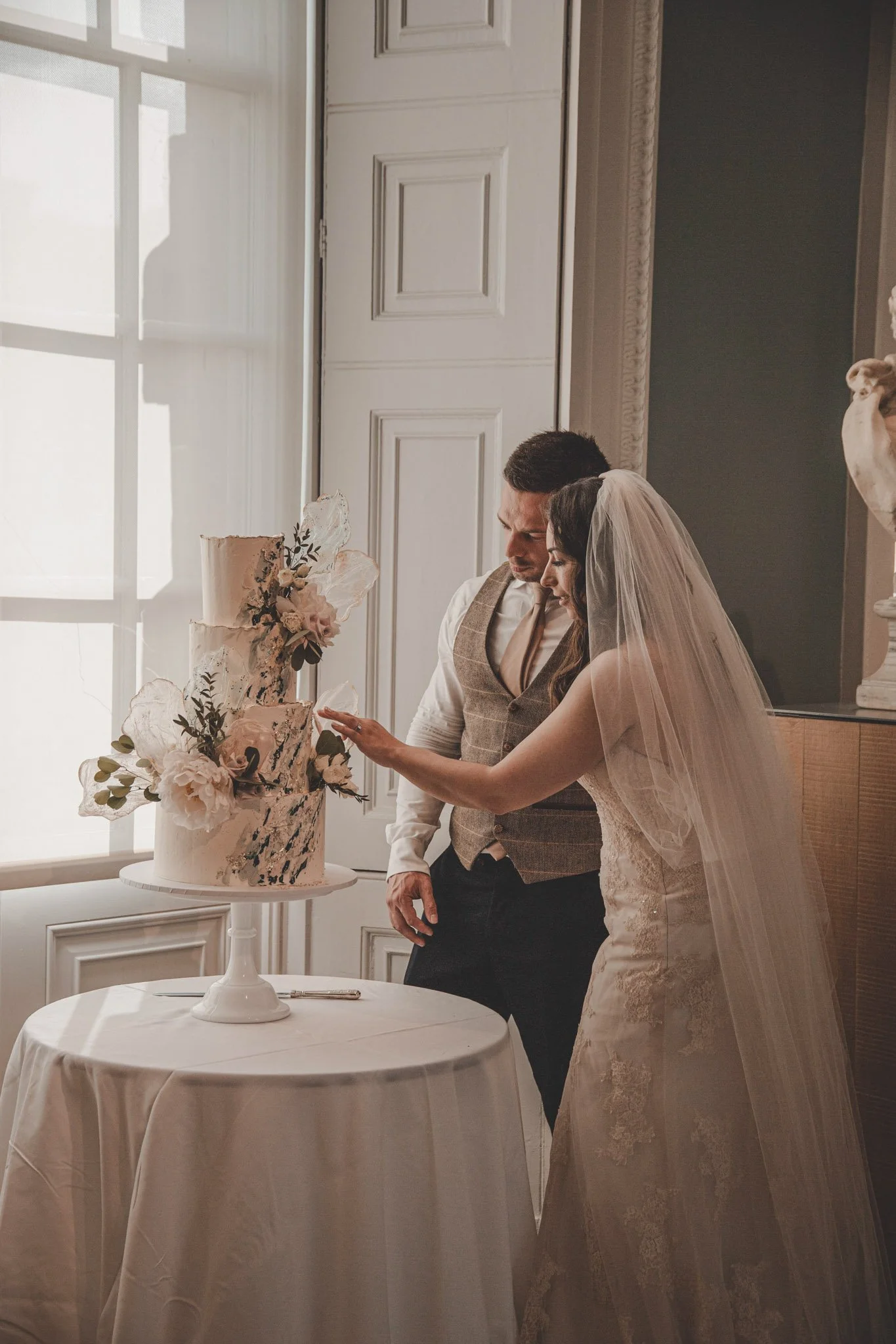 Bride and groom cutting the cake, at Compton Verney Art Gallery and Park 