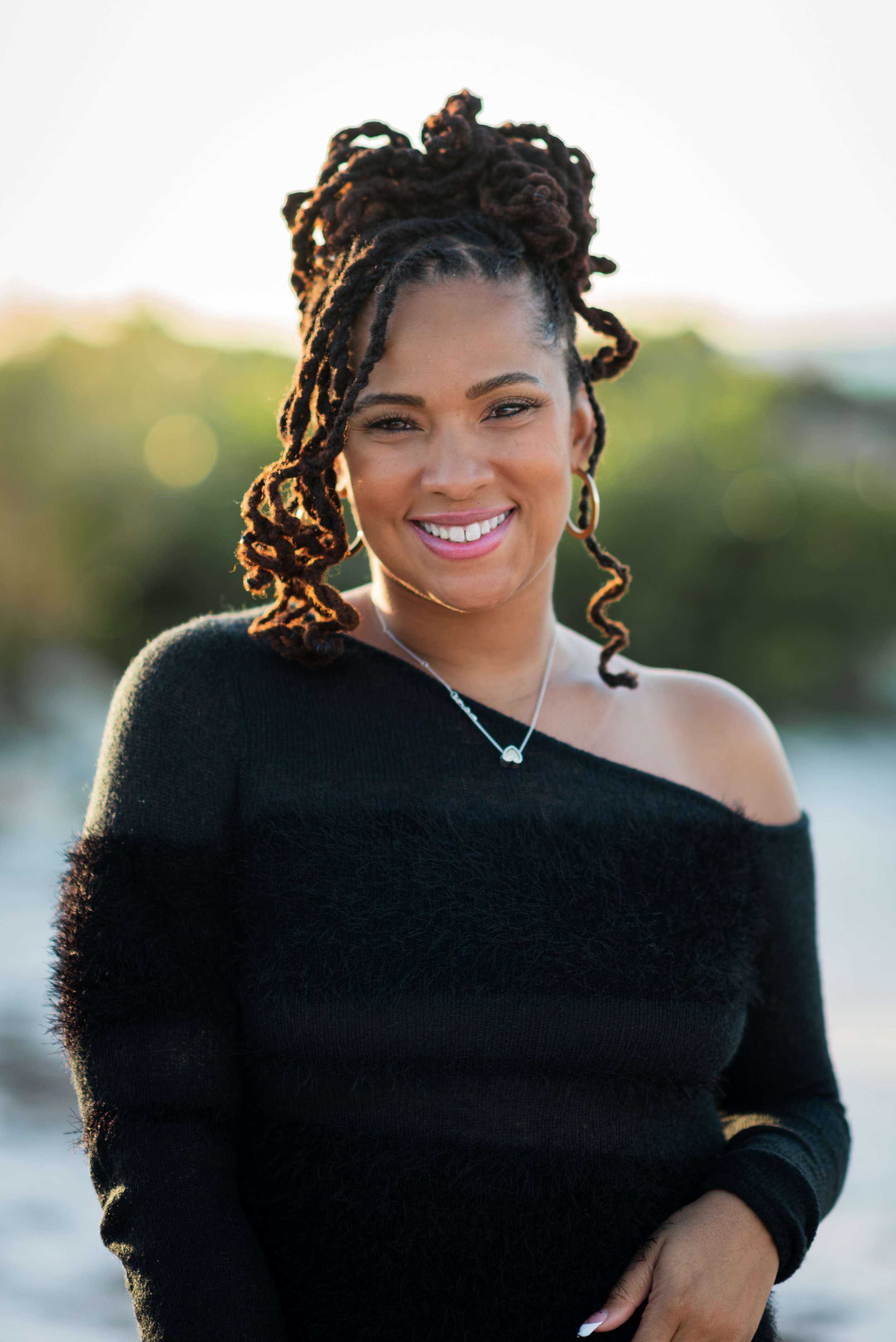 Close-up portrait of a woman smiling at golden hour at Apollo Beach Nature Preserve, Tampa Bay